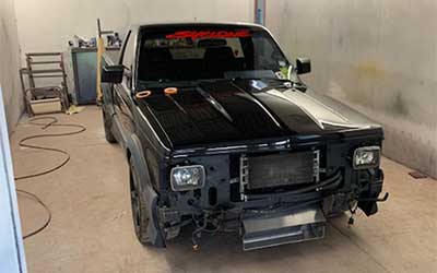 GMC Syclone all the plastic cladding repainted in matte black.
